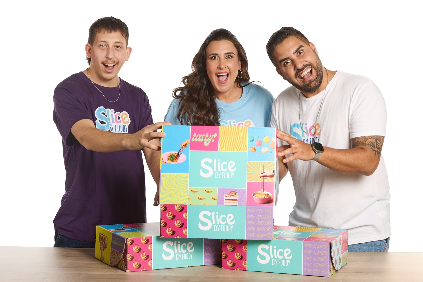 The Slice by Foody team holding the cooking kit boxes